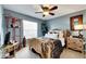 Serene bedroom with light blue walls, wood bed frame and carpeted floors at 10511 Martinique Isle Dr, Tampa, FL 33647