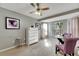 Bright bedroom with neutral walls, carpeted floors and a small sitting area at 10511 Martinique Isle Dr, Tampa, FL 33647