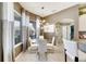 Breakfast nook with glass table and white chairs, offering a bright and airy space at 10511 Martinique Isle Dr, Tampa, FL 33647