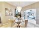 A dining room with a glass table and neutral decor at 10511 Martinique Isle Dr, Tampa, FL 33647