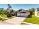 Two-story house with a three-car garage and lush green grass at 10511 Martinique Isle Dr, Tampa, FL 33647