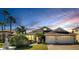 Two-story house with two-car garage and palm trees in front at 10511 Martinique Isle Dr, Tampa, FL 33647