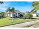 Two-story house with a two-car garage and palm trees in front at 10511 Martinique Isle Dr, Tampa, FL 33647