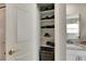 Well-organized linen closet with shelves for towels at 10511 Martinique Isle Dr, Tampa, FL 33647