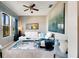 Living room with white sectional sofa and large abstract art at 10511 Martinique Isle Dr, Tampa, FL 33647