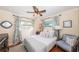 Cozy bedroom with a queen-size bed, ceiling fan, and ample natural light at 11194 91St Ave, Seminole, FL 33772