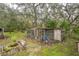 Chicken coop with run in a wooded backyard setting at 11730 Chipley St, New Port Richey, FL 34654