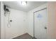 Small hallway with door and laminate flooring at 11730 Chipley St, New Port Richey, FL 34654