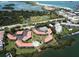 Aerial view of waterfront community with pool, tennis courts, and boat slips at 1515 Pinellas Bayway S # 35, Tierra Verde, FL 33715
