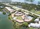 Aerial view of waterfront community with tennis courts and pool at 1515 Pinellas Bayway S # 35, St Petersburg, FL 33715