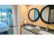 Bright bathroom with double sinks, granite countertops, and large mirrors at 1515 Pinellas Bayway S # 35, Tierra Verde, FL 33715