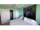 Bedroom with king-size bed, access to bathroom, and large art piece at 1515 Pinellas Bayway S # 35, Tierra Verde, FL 33715