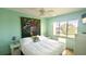Bedroom with king-size bed, ceiling fan, and view from window at 1515 Pinellas Bayway S # 35, Tierra Verde, FL 33715