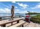 Enjoy outdoor dining on this deck overlooking the water; features a grill and seating at 1515 Pinellas Bayway S # 35, Tierra Verde, FL 33715