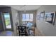 Casual dining area with glass table and chairs, and balcony access at 1515 Pinellas Bayway S # 35, Tierra Verde, FL 33715