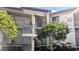 Exterior view of condo building with stairs and landscaping at 1515 Pinellas Bayway S # 35, Tierra Verde, FL 33715