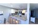 Kitchen with breakfast bar, granite countertops, and white cabinetry at 1515 Pinellas Bayway S # 35, Tierra Verde, FL 33715