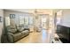 Living room with reclining sofa, armchair, and tiled floor at 1515 Pinellas Bayway S # 35, Tierra Verde, FL 33715