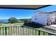 Condo balcony view showcasing water, boat, and neighboring building at 1515 Pinellas Bayway S # 35, Tierra Verde, FL 33715