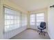 Bright sunroom with large windows, vertical blinds, and comfortable office chair at 2025 Heathfield Cir # 2025, Sun City Center, FL 33573