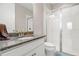 Bathroom with granite countertop, shower, and toilet at 2101 Sunset Wind Loop, Oldsmar, FL 34677