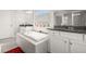 Spa-like bathroom with soaking tub, granite counters, and white cabinets at 2101 Sunset Wind Loop, Oldsmar, FL 34677