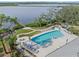 Inviting community pool with surrounding lounge chairs and waterfront access at 2101 Sunset Wind Loop, Oldsmar, FL 34677