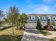 Two-story townhome with blue siding, two-car garage, and landscaped front yard at 2101 Sunset Wind Loop, Oldsmar, FL 34677