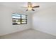 Well-lit bedroom featuring a window and ceiling fan at 2122 Hereford Dr # 511, Sun City Center, FL 33573