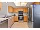 Clean kitchen with stainless steel appliances and light wood cabinets at 2122 Hereford Dr # 511, Sun City Center, FL 33573