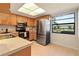 Clean kitchen with stainless steel appliances and light wood cabinets at 2122 Hereford Dr # 511, Sun City Center, FL 33573