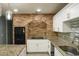 Modern kitchen boasting granite countertops and brick accent wall at 3515 Buckboard Ln, Brandon, FL 33511