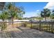 Enjoy the spacious backyard from the wooden deck, surrounded by lush landscaping and privacy fence at 3918 W Fig St, Tampa, FL 33609