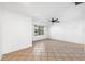 Spacious living room with neutral paint, tile flooring, and a ceiling fan at 3918 W Fig St, Tampa, FL 33609