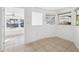 Bright room with natural light pouring through windows, seamlessly connecting to another room at 3918 W Fig St, Tampa, FL 33609