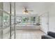 Bright sunroom featuring tile flooring, large windows, and a ceiling fan at 3918 W Fig St, Tampa, FL 33609