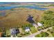Aerial view showcasing multiple homes and the surrounding marshland at 4021 Eagle Nest Dr, Hernando Beach, FL 34607