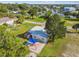 Aerial view of a home with a patio, firepit, and lush landscaping at 4021 Eagle Nest Dr, Hernando Beach, FL 34607