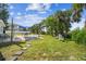 Backyard patio with seating area, firepit, and lush landscaping at 4021 Eagle Nest Dr, Hernando Beach, FL 34607