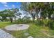 Relaxing backyard firepit area with stone seating and landscaping at 4021 Eagle Nest Dr, Hernando Beach, FL 34607