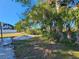 Backyard with firepit, palm trees, and landscaping at 4021 Eagle Nest Dr, Hernando Beach, FL 34607