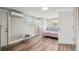 Bright bedroom with a double bed, a small desk, and laminate wood flooring at 4021 Eagle Nest Dr, Hernando Beach, FL 34607