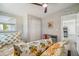 Charming bedroom with floral bedding, a desk and chair, and wood-look floors at 4021 Eagle Nest Dr, Hernando Beach, FL 34607