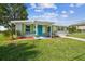 Charming bungalow with teal door and vibrant green shutters at 4021 Eagle Nest Dr, Hernando Beach, FL 34607