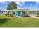 Charming single story home with teal door and green shutters at 4021 Eagle Nest Dr, Hernando Beach, FL 34607
