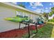 Exterior view showing kayak storage and manicured landscaping at 4021 Eagle Nest Dr, Hernando Beach, FL 34607