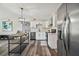 Bright kitchen boasts stainless steel appliances and an island with seating at 4021 Eagle Nest Dr, Hernando Beach, FL 34607
