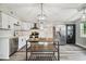Modern kitchen with white cabinets, stainless steel appliances and island at 4021 Eagle Nest Dr, Hernando Beach, FL 34607