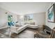 Living area with white sectional and wood-look flooring at 4021 Eagle Nest Dr, Hernando Beach, FL 34607