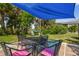 Outdoor patio with table, chairs, shade sail, and hammock at 4021 Eagle Nest Dr, Hernando Beach, FL 34607